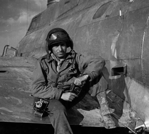 Tony Vaccaro in 1945 sitting on the wing of a plane holding his 35-millimeter Argus C3 camera that he had bought as a teenager.