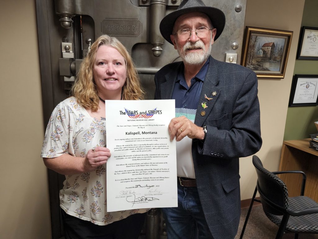 The Stars and Stripes Proclamation is presented to Kalispell City Clerk Aimee Bruckhorst