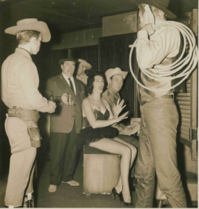 four actors dressed as cowboys and one actress.